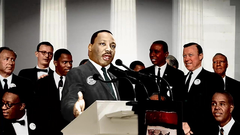 Martin Luther King, Jr. stands at a podium giving a speech.