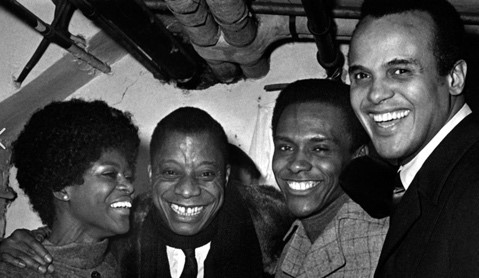 a photograph of three African American men and one woman, including author James Baldwin.